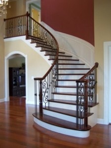 Curved stairs by a curved red wall