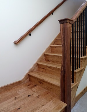 Materials in stock are less expensive — e.g., red oak is the most common hardwood and among the least expensive.