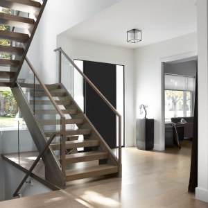 open rise stair and front door from inside a foyer